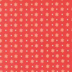 a repeating pattern of red flowers with white polka dots on a red background.