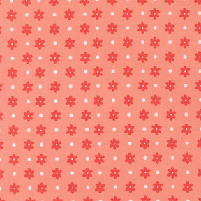 a repeating pattern of red flowers with white polka dots on a peach-colored background.