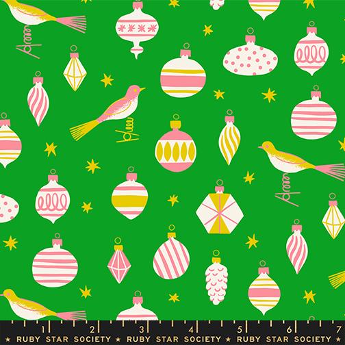 The image is a collage of various Christmas ornaments and birds against a green background.