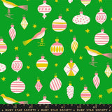 The image is a collage of various Christmas ornaments and birds against a green background.