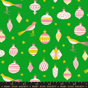 The image is a collage of various Christmas ornaments and birds against a green background.
