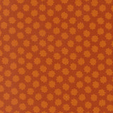 a repeating pattern of orange and brown flowers or shapes on a brown background.
