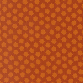 a repeating pattern of orange and brown flowers or shapes on a brown background.