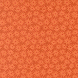 a repeating pattern of orange flowers on a dark background.