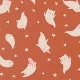 a playful and whimsical pattern of ghost-like figures and stars on a brown background.