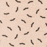 a repeating pattern of black bats against a light beige background with small orange dots scattered throughout.