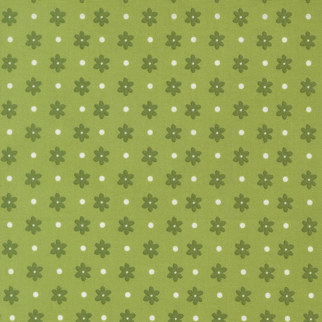a repeating pattern of green flowers with white polka dots on a green background.