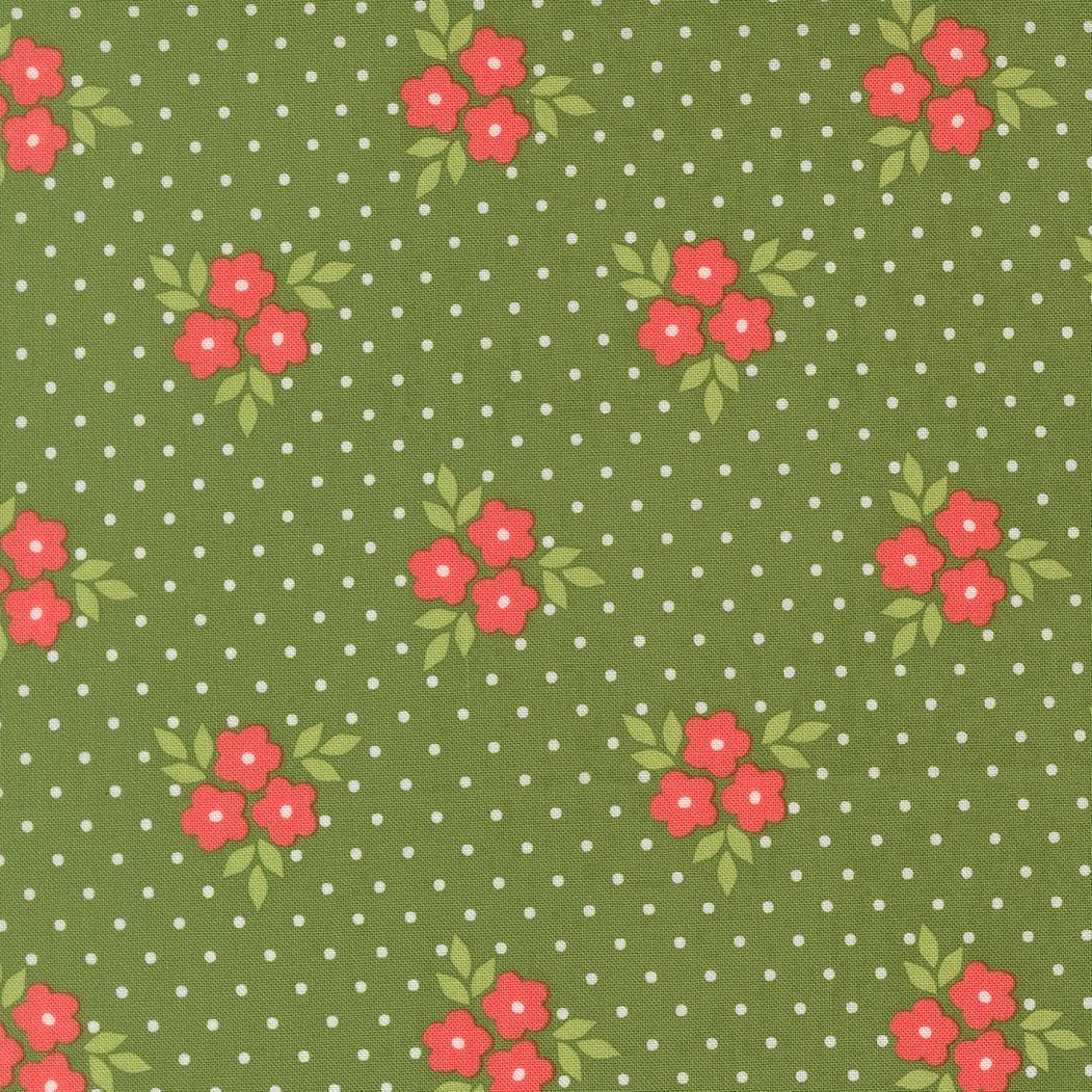 a pattern of green fabric with white polka dots, each adorned with red flowers and green leaves.