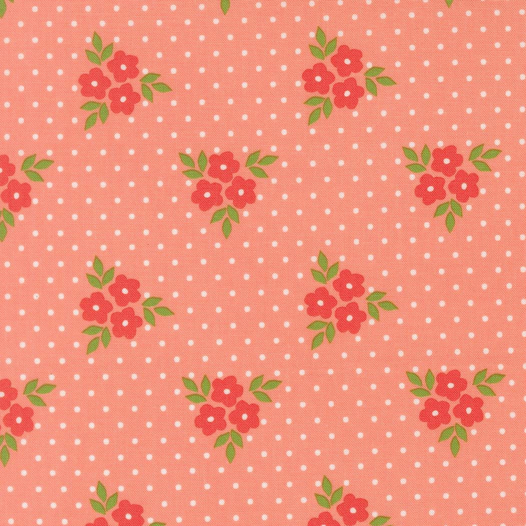 a repeating pattern of red flowers with green leaves against a pink background with white polka dots.