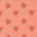 a repeating pattern of red flowers with green leaves against a pink background with white polka dots.