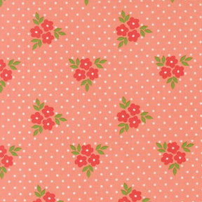 a repeating pattern of red flowers with green leaves against a pink background with white polka dots.