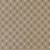a repeating pattern of brown flowers with white polka dots on a beige background.