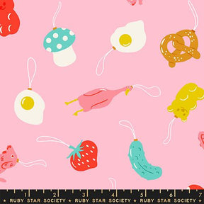 various colorful and whimsical objects, including a mushroom, a fried egg, a teddy bear, a pickle, a strawberry, and a bear, all set against a pink background.