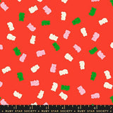 a vibrant red background with a playful pattern of pink and green gummy bears scattered across it.