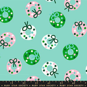 a pattern of Christmas wreaths with green bows and pink and white polka dots on a light blue background.