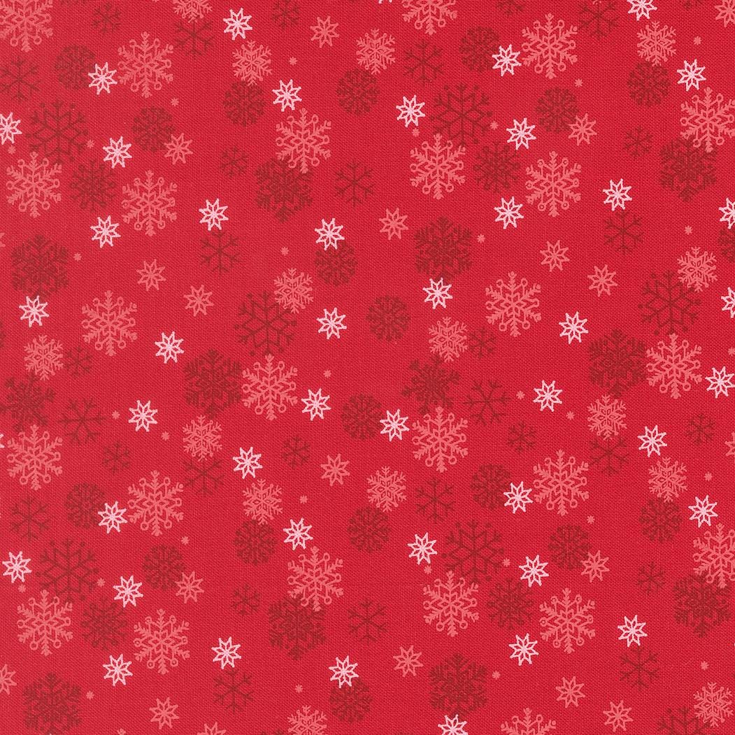 a repeating pattern of red snowflakes on a red background.