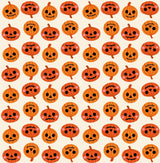 a repeating pattern of stylized pumpkins with faces, arranged in a grid-like layout.