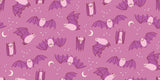 a repeating pattern of bats and crescent moons against a pink background.