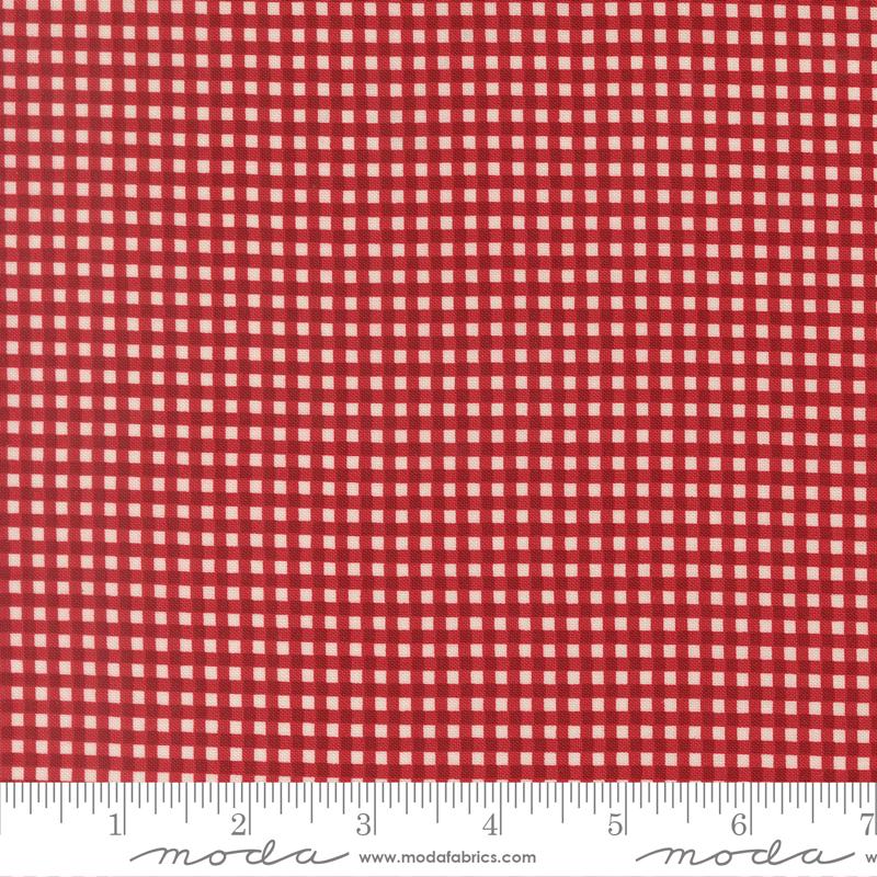a close-up view of a red and white checkered pattern, with a ruler for scale at the bottom.