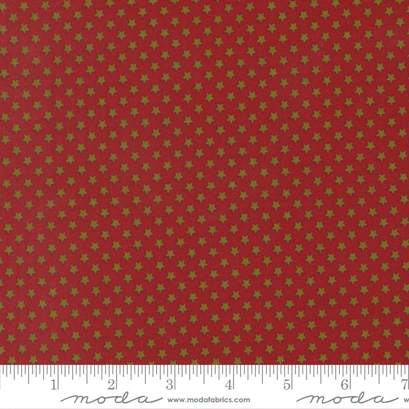 a red fabric with a repeating pattern of gold stars on it. The fabric appears to be a fabric with a star pattern, possibly used for clothing or home decor.