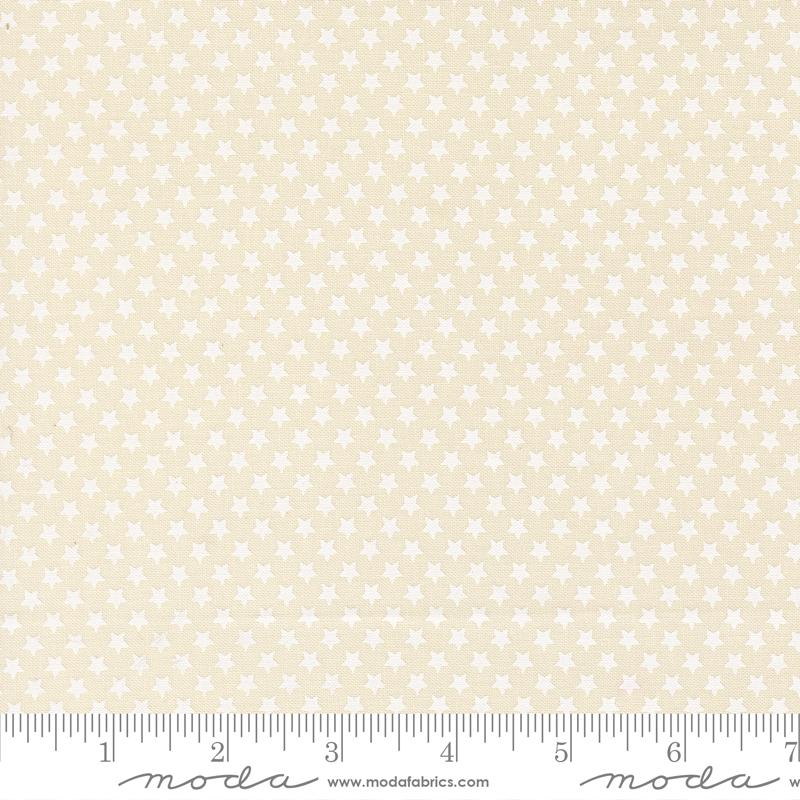 a fabric with a repeating pattern of white stars on a beige background.