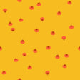 a repeating pattern of small red and orange circles or dots on a bright yellow background.