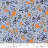 The image is a fabric with a floral pattern featuring orange pumpkins, black roses, and green leaves. The pattern is repeated across the fabric, creating a visually appealing and intricate design.