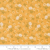 The image is a fabric with a repeating pattern of white flowers and leaves on a yellow background.