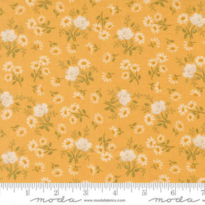 The image is a fabric with a repeating pattern of white flowers and leaves on a yellow background.