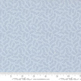 a fabric with a repeating pattern of light blue leaves or branches, creating a textured and leafy appearance.