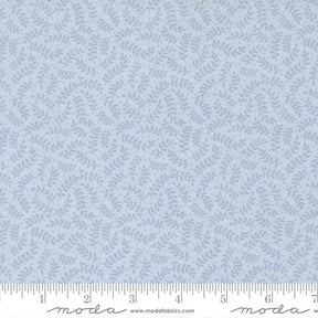 a fabric with a repeating pattern of light blue leaves or branches, creating a textured and leafy appearance.
