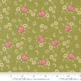 The image is a fabric with a floral pattern of pink roses and white daisies on a green background.