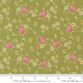 The image is a fabric with a floral pattern of pink roses and white daisies on a green background.