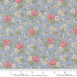 The image is a fabric with a floral pattern of pink roses and white daisies on a light blue background.