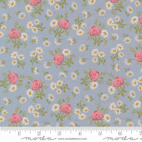 The image is a fabric with a floral pattern of pink roses and white daisies on a light blue background.