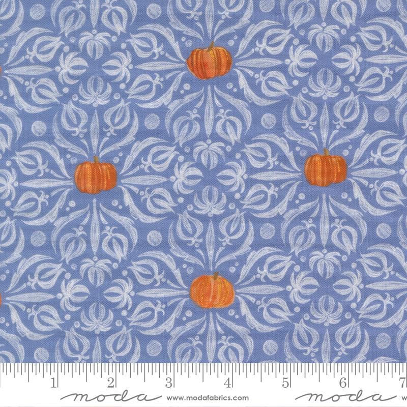 a pattern of pumpkins and leaves on a blue background with a white floral design.