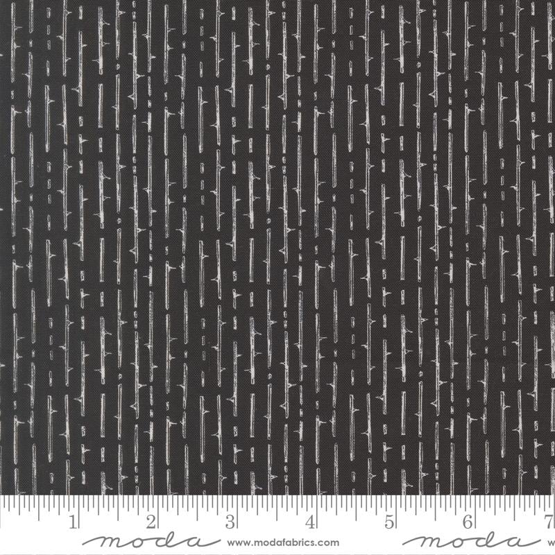 The image is a close-up of a black and white striped fabric with a repeating pattern of vertical lines.