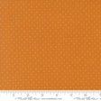 The image is a close-up of a fabric with a polka dot pattern, featuring a gradient of orange and white colors.