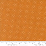 The image is a close-up of a fabric with a polka dot pattern, featuring a gradient of orange and white colors.