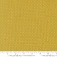 The image is a close-up of a fabric with a yellow background and white polka dots.