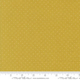 The image is a close-up of a fabric with a yellow background and white polka dots.