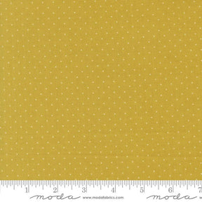 The image is a close-up of a fabric with a yellow background and white polka dots.