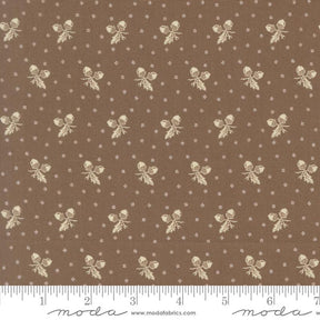 a brown fabric with a repeating pattern of white acorns and leaves. The pattern is composed of small white dots, creating a visually appealing and intricate design. The fabric appears to be a piece of clothing or textile, with the acorn and leaf motifs possibly used for embellishment or decoration.