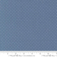 a close-up view of a fabric with a blue background and white polka dots. The fabric appears to be a type of textile, possibly used for clothing or home decor.