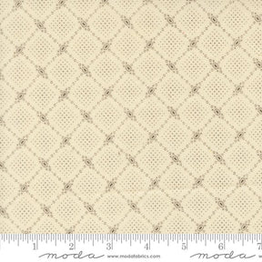 The image is a close-up of a fabric with a diamond pattern, featuring a repeating diagonal grid of small squares or diamonds.