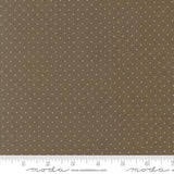 The image is a close-up of a fabric with a brown background and white polka dots.