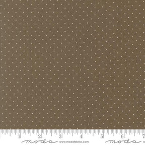 The image is a close-up of a fabric with a brown background and white polka dots.
