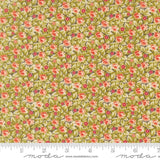 The image is a close-up of a fabric with a floral pattern, featuring small red flowers and green leaves. The fabric appears to be a type of cotton or linen material, with a repeating pattern of flowers and leaves. The image does not contain any text or other discernible objects or actions.