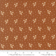 The image is a fabric with a repeating pattern of brown and white acorns or leaves, creating a visually appealing and textured design.