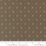 The image is a close-up of a brown fabric with a diamond pattern, featuring small white dots arranged in a repeating diamond shape.